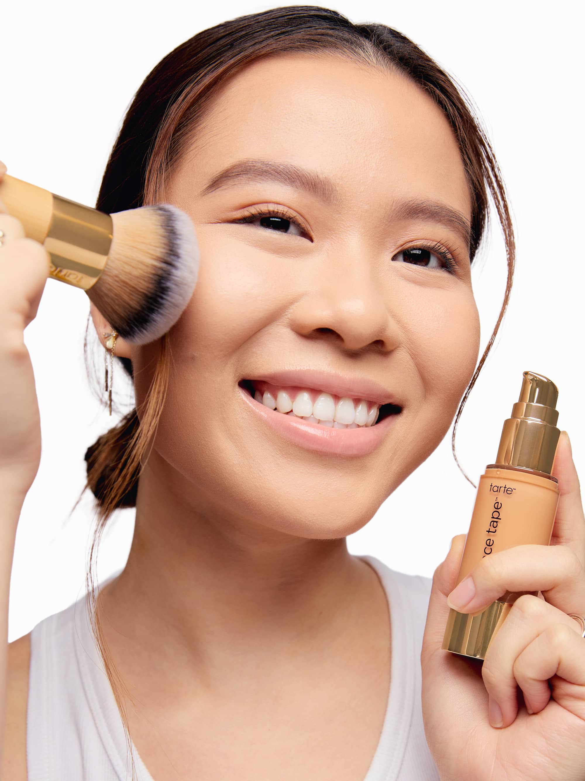 Woman applying makeup with buffer brush