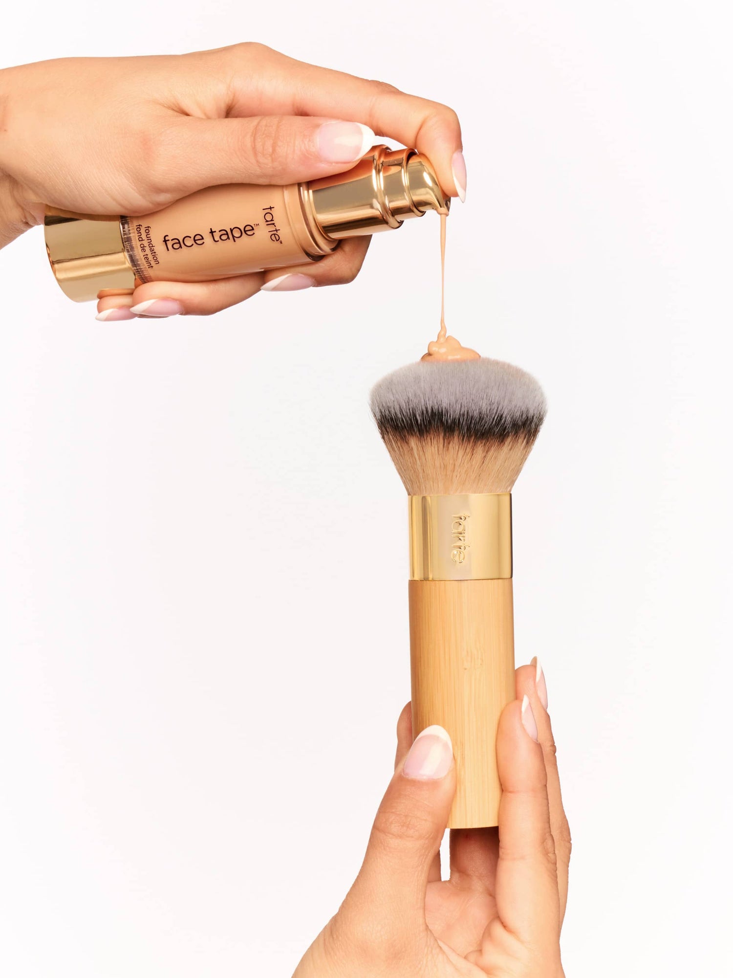 Buffer brush with gold handle held by a hand